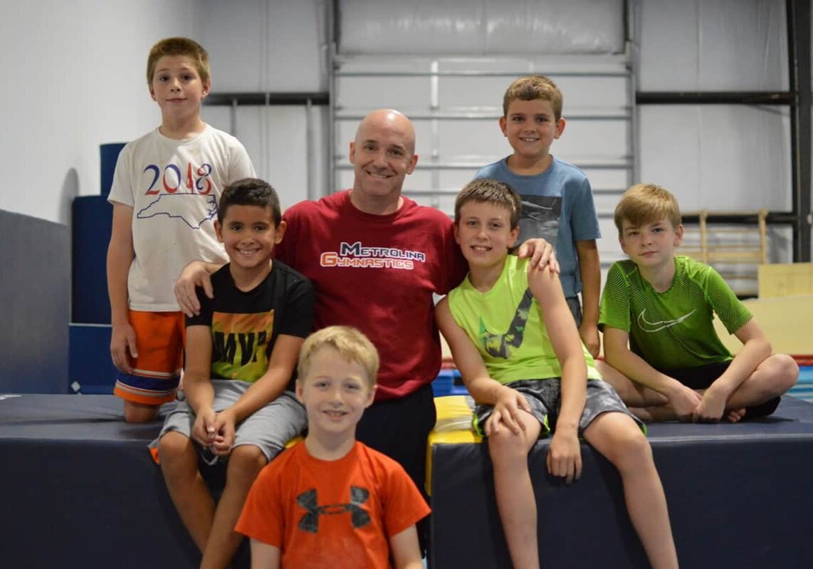 Nick Baker coaching gymnasts