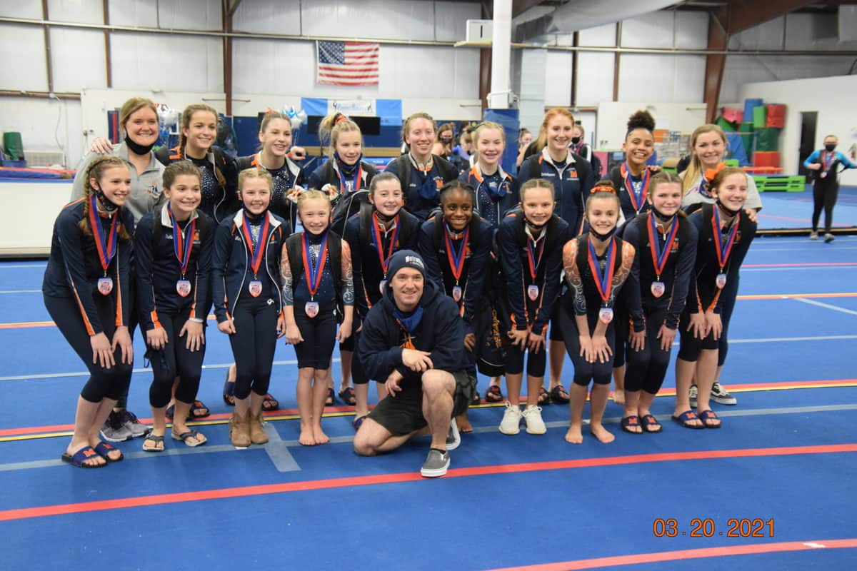 Metrolina Gymnastics team on the competition floor